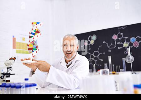 Genetics is his passion. Portrait of a mature male scientist holding a model of a DNA molecule in his lab. Stock Photo