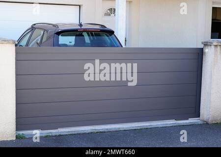 portal aluminum sliding grey metal gate of modern gray suburb house entrance Stock Photo