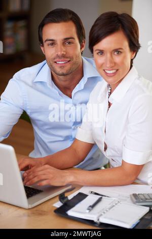 Partners in business. two colleagues working together at a laptop. Stock Photo