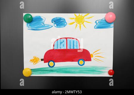 Adorable child's drawing with magnets on refrigerator  door, closeup Stock Photo