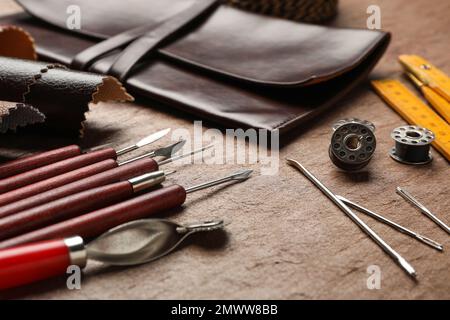 Leather samples and tools on brown table, closeup Stock Photo