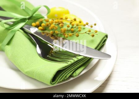 Festive Easter table setting with beautiful mimosa flowers, closeup Stock Photo