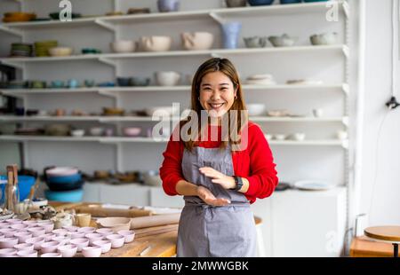 Young woman working in a pottery studio Stock Photo