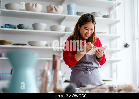 Young woman working in a pottery studio Stock Photo