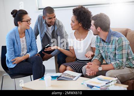 Casual creatives. a diverse group of designers having a meeting around a coffee table. Stock Photo