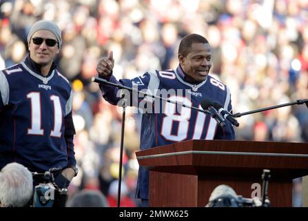 Members of the New England Patriots 2001 Super Bowl XXXVI team Lawyer Milloy,  left, and Drew Bledsoe, right, high five while standing on stage near  Patriots owner Robert Kraft, center, as they