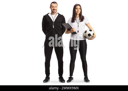 Full length portrait of a male and female football coaches posing isolated on white background Stock Photo