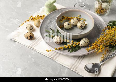 Festive Easter table setting with beautiful mimosa flowers Stock Photo