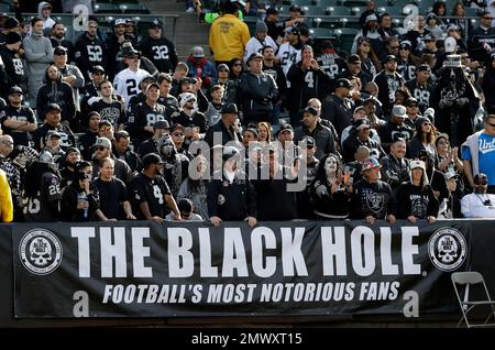 Raiders fans in the Black Hole cheer during the first half of an NFL  football game against the …