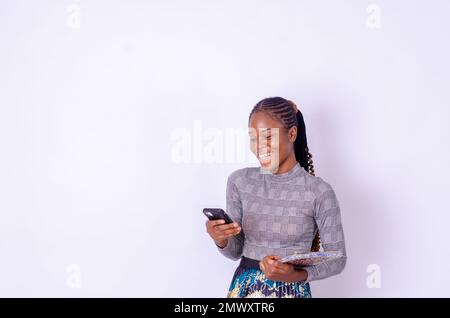 photo of a lady using her cellphone smiling Stock Photo