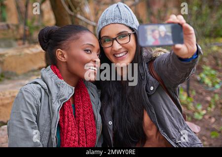 Happy moments at college. two female friends taking a selfie on campus. Stock Photo