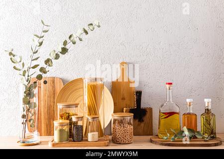 various kinds of cutting wooden boards and glass containers for storing products on the kitchen countertop. Eco-friendly items .kitchen background Stock Photo