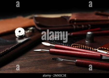 Leather samples and tools on wooden table Stock Photo