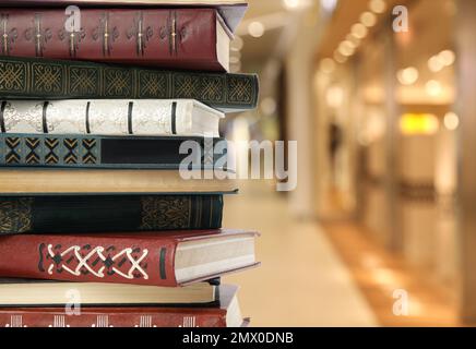 Collection of different books against blurred background, space for text Stock Photo