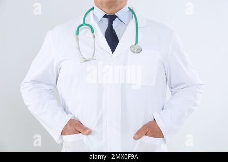 Senior doctor with stethoscope on white background, closeup Stock Photo
