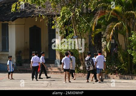 Students playing in the courtyard of a public school in Luang Prabang, Laos Stock Photo