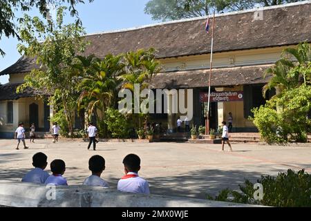 Students playing in the courtyard of a public school in Luang Prabang, Laos Stock Photo