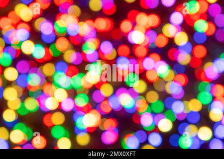 Abstract rainbow colours blurred light circles whith bokeh effect on on a dark background with red shadows Stock Photo