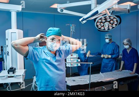 Surgical team getting ready for beginning of surgical operation in operating room Stock Photo