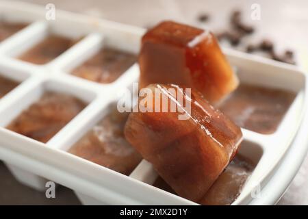 Ice cube tray with frozen coffee on grey table, closeup. Space for text  Stock Photo - Alamy