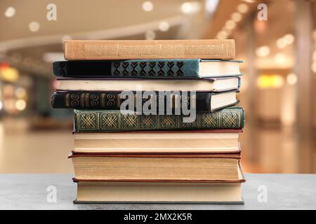 Collection of different books on table against blurred background Stock Photo