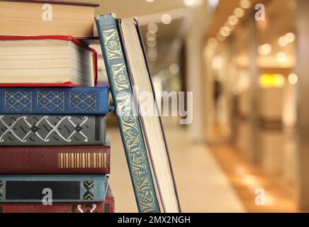 Collection of different books against blurred background, space for text Stock Photo