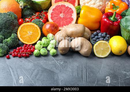 Different products rich in vitamin C on grey table Stock Photo