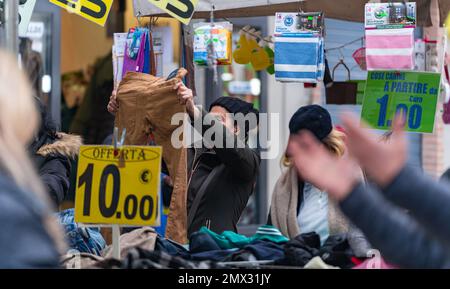 women looking for clothes in the stalls in the city. rome, italy. city life concept Stock Photo