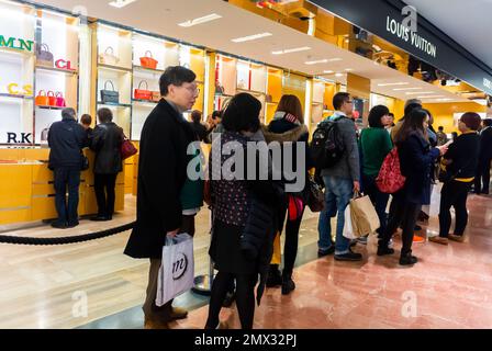 Paris, France, Chinese WOmen, men,Tourists, Queuing while Shopping in French Department Store, Galeries Lafayette Stock Photo