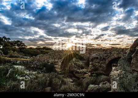 Photograph of an idyllic landscape of the countryside of Extremadura. Old bridge used for the access to the water mills for flour production. Stock Photo
