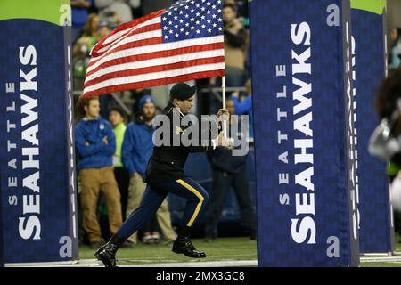 Staff Sgt. John McLaughlin leads the Seattle Seahawks onto the