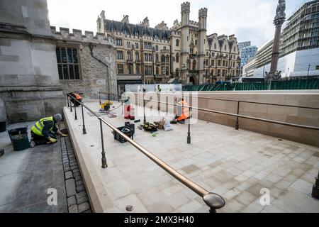 Workers from specialist heritage builders Daedalus Conservation puts the final touches to building works outside the Great West Door of Westminster Abbey, in London, completing the first significant change in twenty-five years, allowing step-free access. Picture date: Thursday February 2, 2023. Stock Photo