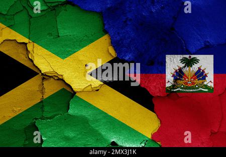 flags of Jamaica and Haiti painted on cracked wall Stock Photo