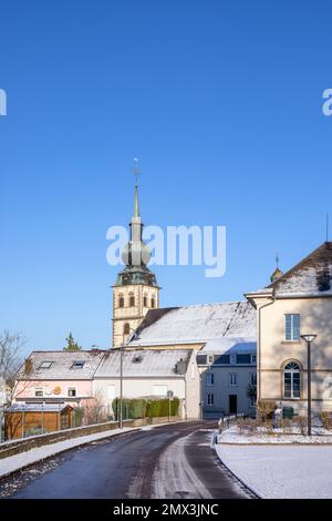 Europe, Luxembourg, Koerich, Views of Église Saint-Remi (Church of Saint Remi) from Neie Wée in Winter Snow Stock Photo