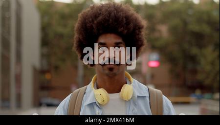 Portrait of a young funky african american man with afro hair looking at camera seriously Stock Photo