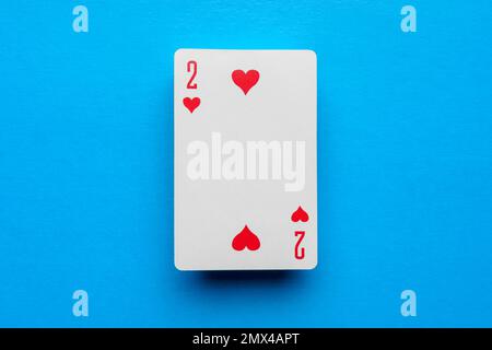 Playing card deuce of hearts on a blue background Stock Photo