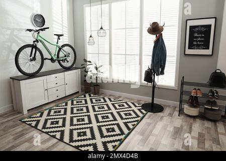 Hallway interior with stylish furniture and green bicycle Stock Photo