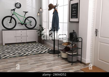 Hallway interior with stylish furniture and green bicycle Stock Photo