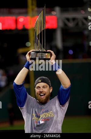 Chicago Cubs outfielder BEN ZOBRIST holds up his MVP trophy