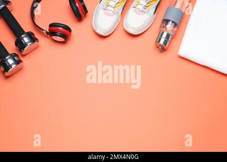 Flat lay composition with sport items on coral background, space for text Stock Photo