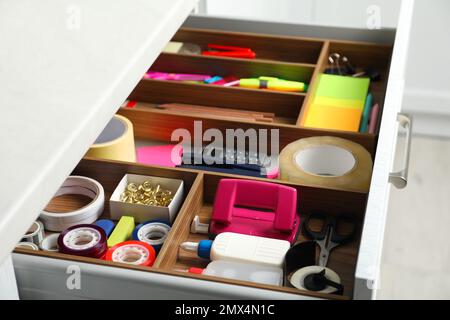 Different stationery in open desk drawer indoors Stock Photo