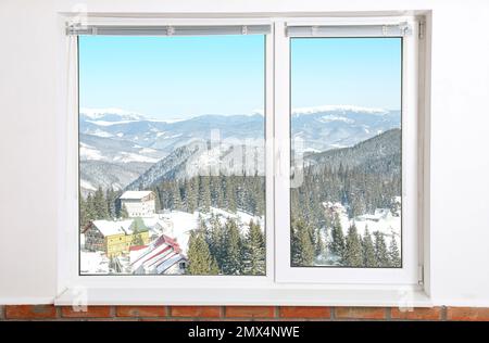 Beautiful view of snowy forest through big window Stock Photo