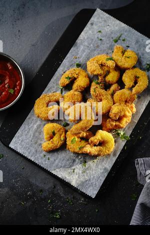 Homemade Popcorn shrimps breaded with cornmeal | Game day appetizer, selective focus Stock Photo