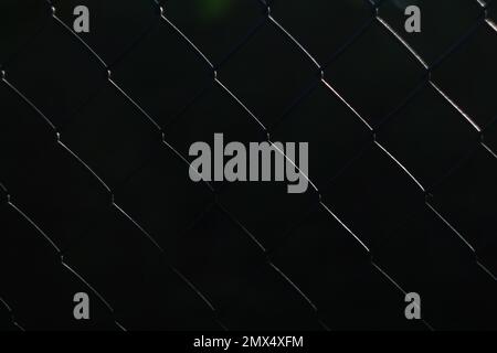 Black chrome Steel Grating seamless structure. Chainlink. Rhombus wire pattern black metal background. Cage metal net in the dark. Abstract black Stock Photo