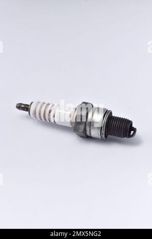 Used motorcycle spark plug isolated on white background. Stock Photo