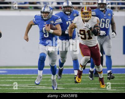 Detroit Lions Matthew Stafford is pursued by San Diego Chargers Vaughn  Martin during the third quarter in Detroit on December 24, 2011. The Lions  beat the Chargers 38-10. With the win the