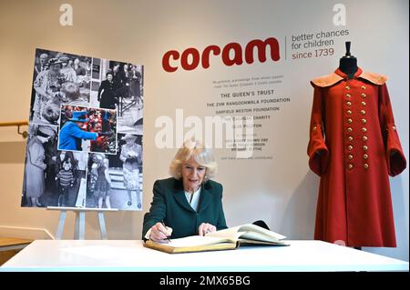 The Queen Consort signs the visitors' book at the 50th anniversary celebrations of children's reading charity Coram Beanstalk in London. Picture date: Thursday February 2, 2023. Stock Photo