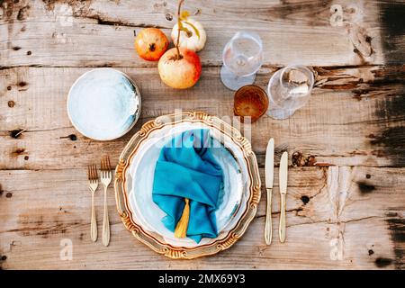 Golden and blue elegant table set on wooden background Stock Photo