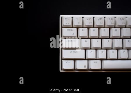 Close up white mechanical keyboard isolated on dark black background Stock Photo