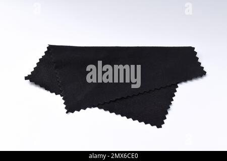 Microfiber cleaning cloth for glasses, or camera lens isolated on white background. Black micro fibre cloth. Stock Photo